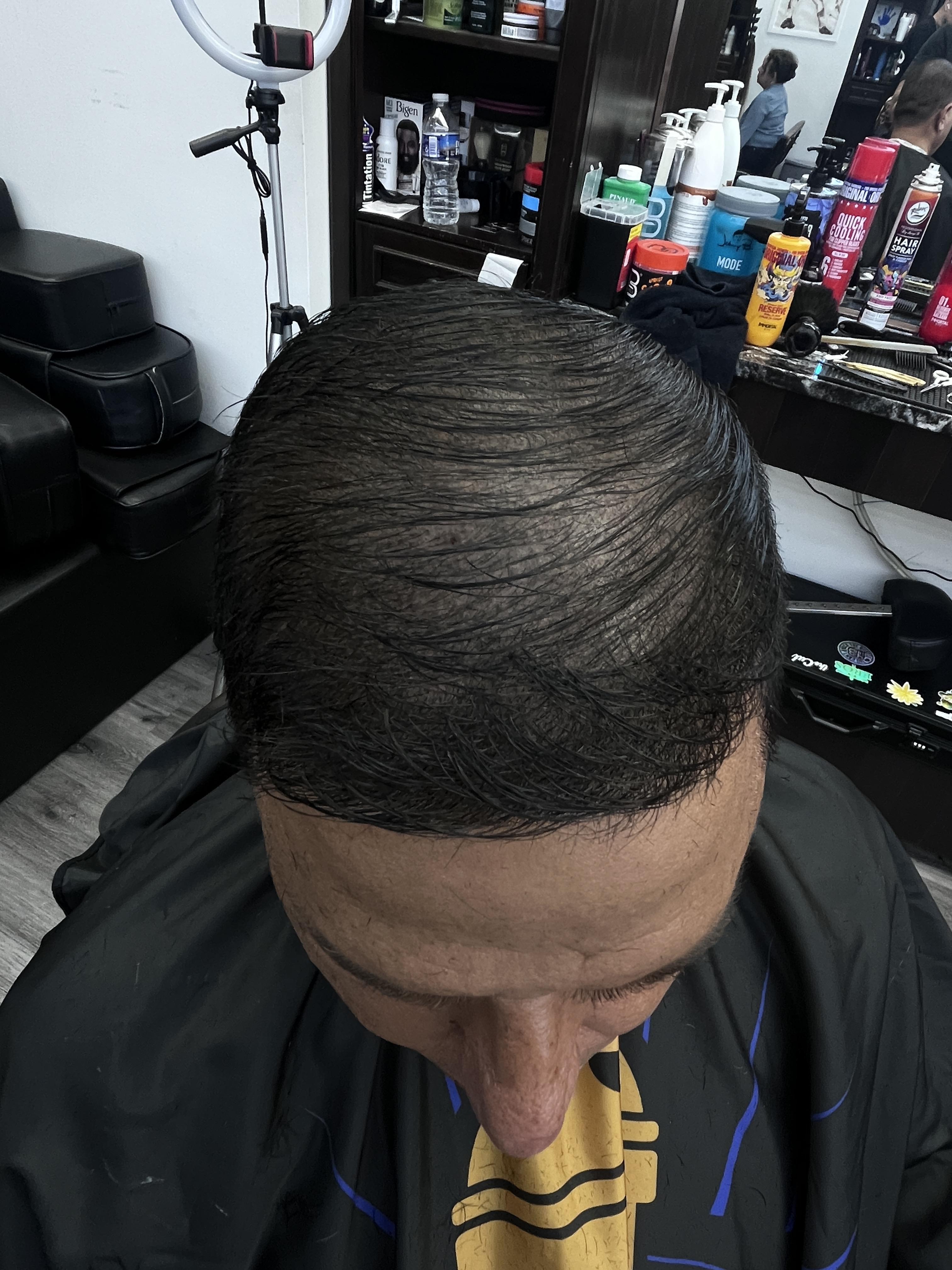 a man is combing his hair with his hands