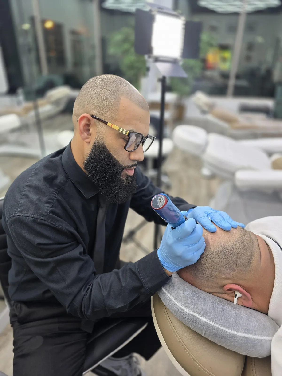 a man cutting another mans hair in a barber shop