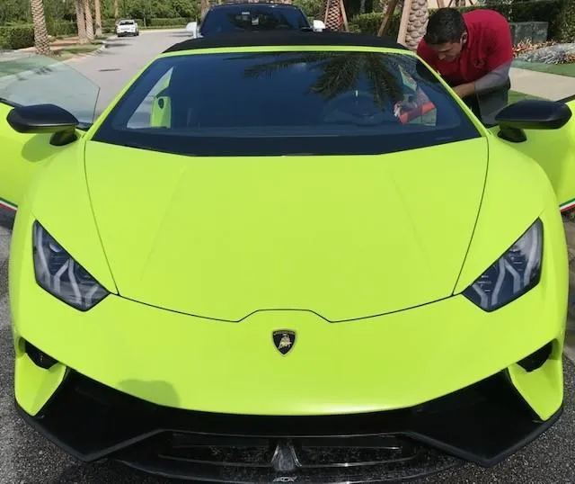 yellow and blue ball on brown wooden fence