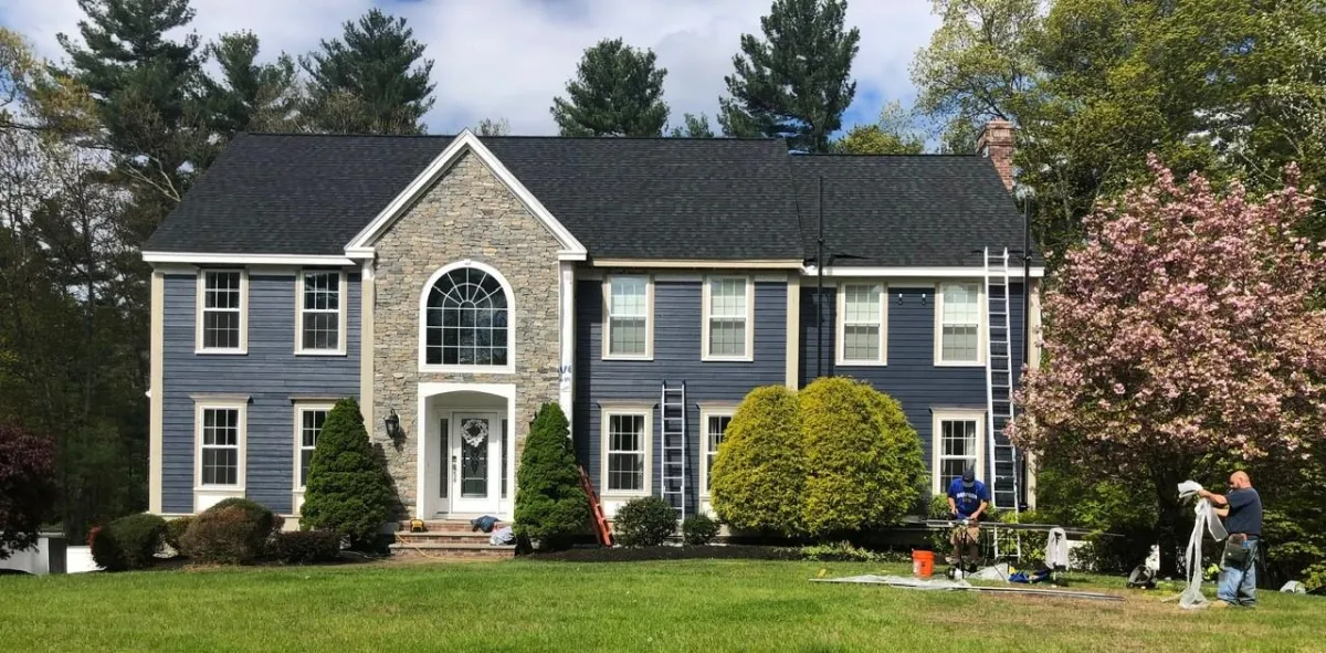 Screened porch with composite deck and white railings installed by McCarthy Exteriors LLC at a residential home in New Hampshire