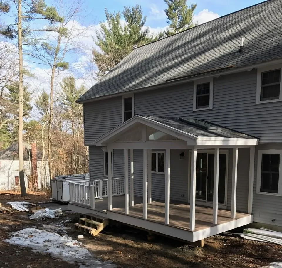 Screened porch and composite deck installation by McCarthy Exteriors LLC on a two-story New Hampshire home