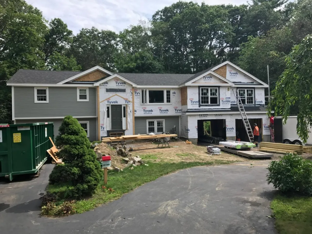 Full home siding renovation in progress with Tyvek wrap by McCarthy Exteriors LLC in New Hampshire