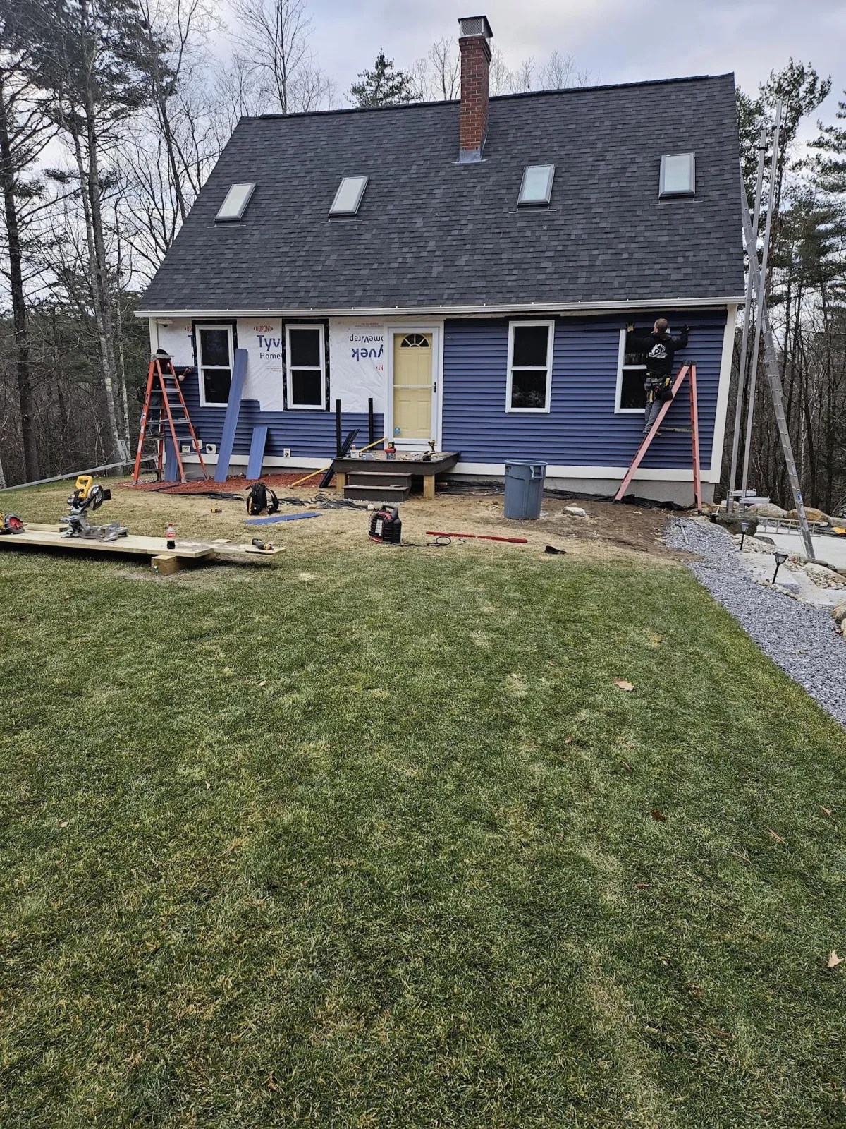 Screened porch with composite deck and white railings installed by McCarthy Exteriors LLC at a residential home in New Hampshire