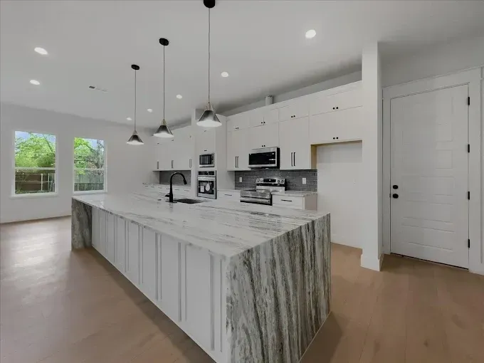 Spacious Arlington, TX bathroom with double vanity, freestanding tub, walk-in shower, modern finishes, and natural light.