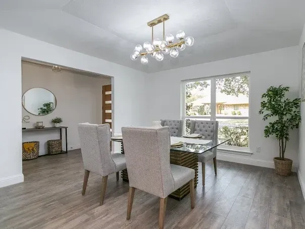 Renovated Arlington, TX bathroom with modern fixtures, marble countertops, glass shower, freestanding tub, and natural light.