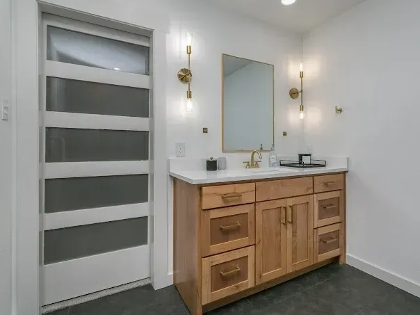 Modern Arlington bathroom featuring large windows, sleek fixtures, marble countertops, and stylish tiled shower.