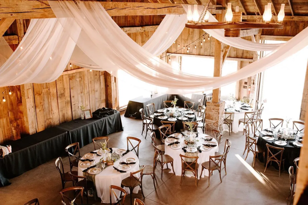 Photo of set tables inside the barn