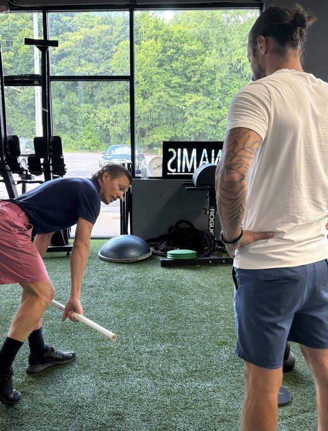 A coach cueing a split squat