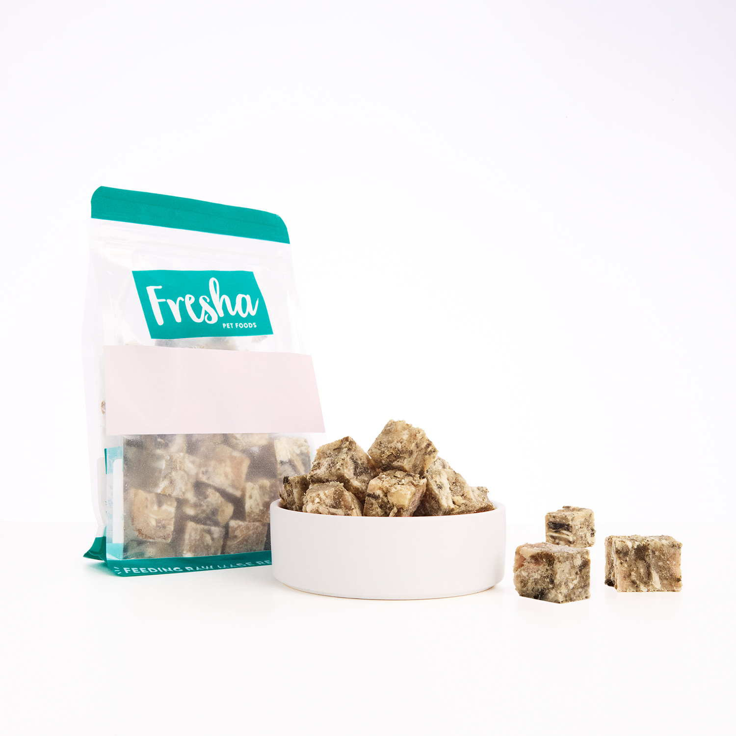 Green beef tripe cubes for dogs in a bowl