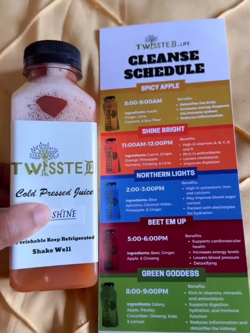 Hand holding an orange TWISSTED cold-pressed juice labeled “SHINE BRIGHT” next to a printed cleanse schedule card. The schedule lists juices like Spicy Apple, Shine Bright, Northern Lights, Beet Em Up, and Green Goddess, along with their ingredients and health benefits. Keywords: TWISSTED juice cleanse, detox schedule, cold-pressed juice guide, healthy juice plan, natural cleanse routine, vitamin-rich juices.