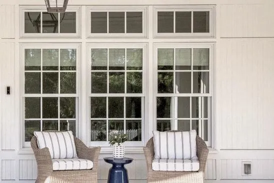 a big windows of a house with white frame