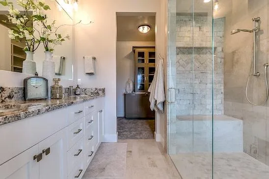 a newly installed bathroom with white cabinets