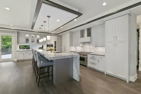 a newly remodeled kitchen with white cabinets