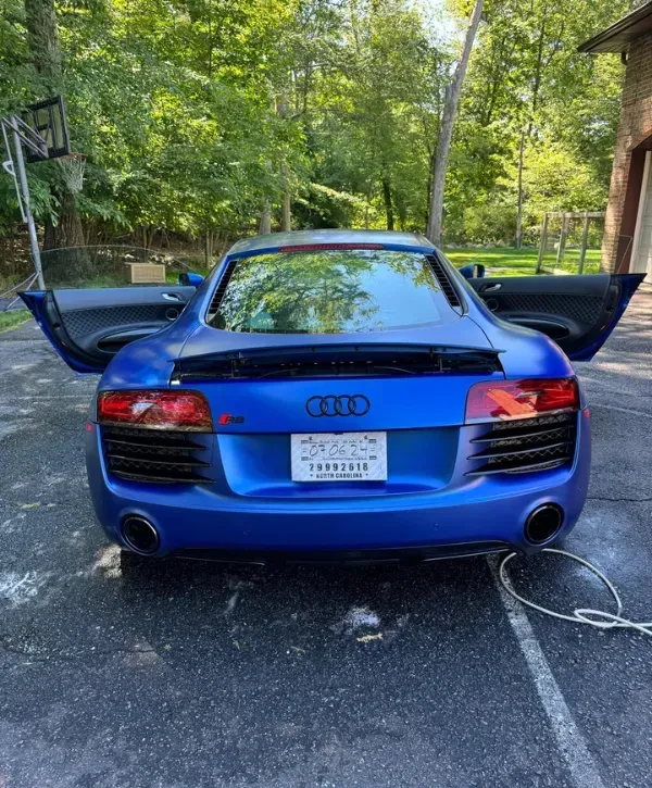  Rear view of Audi R8 V10 showcasing carbon fiber trim and dual exhaust.