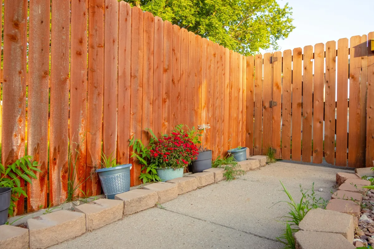 Fence Contractor Gosport - Four Seasons team laying a patio in a Gosport garden