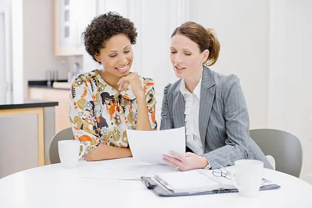 Realtor presenting client with options from a carefully curated listing binder