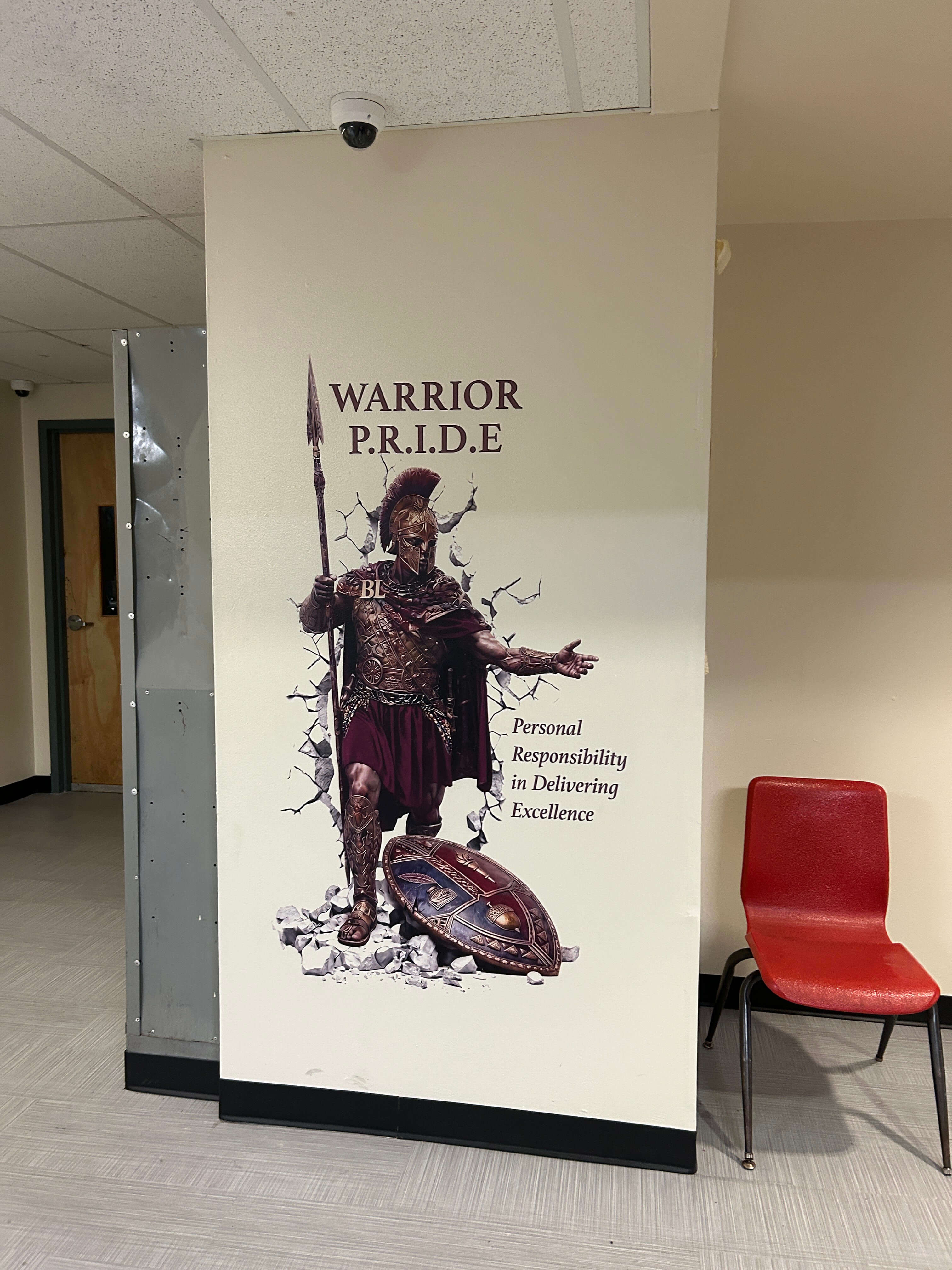 Custom Warrior PRIDE gladiator wall mural printed on a school column by East Coast Mural Pros