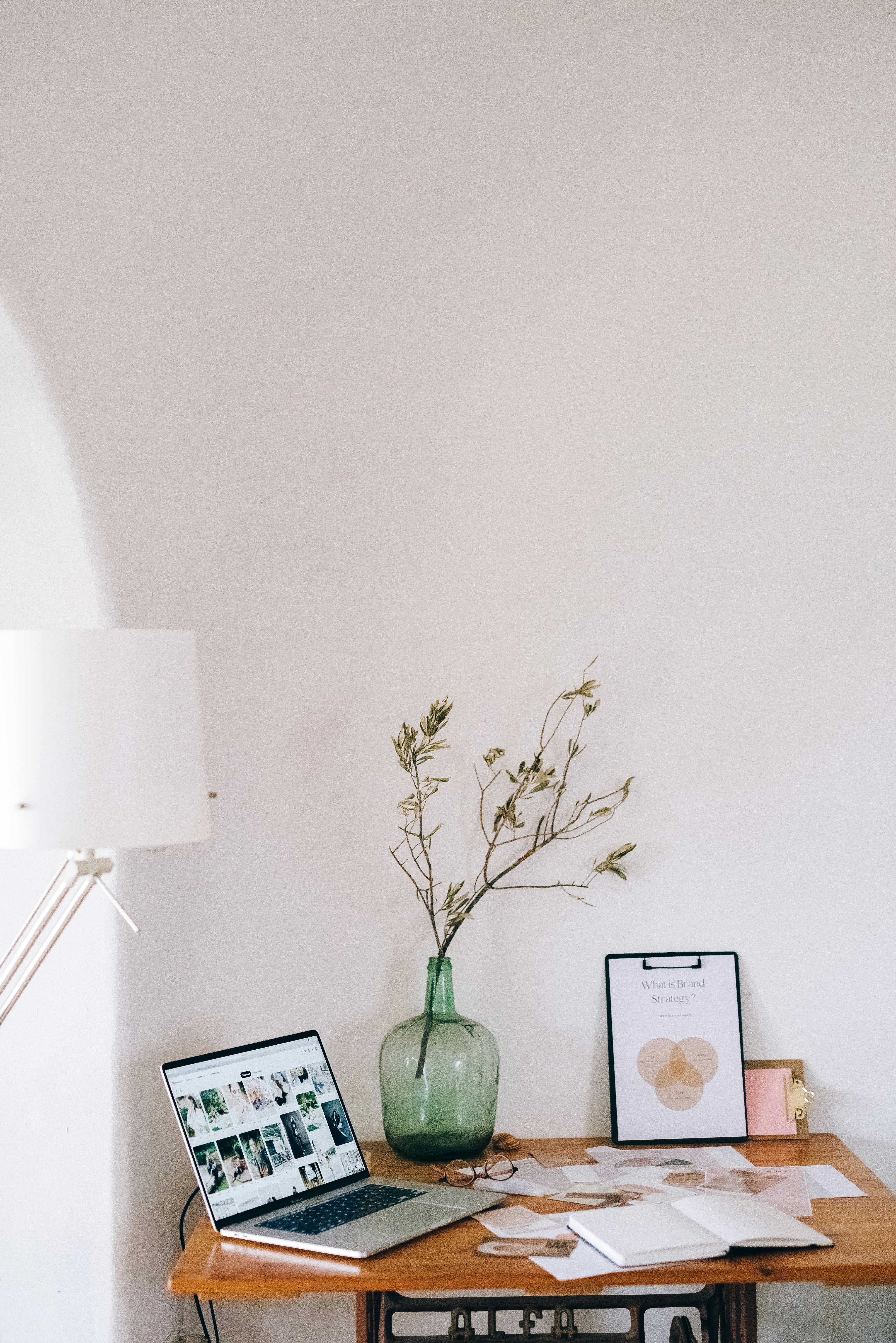 Workspace with laptop and branding materials representing thoughtful strategy and business planning.