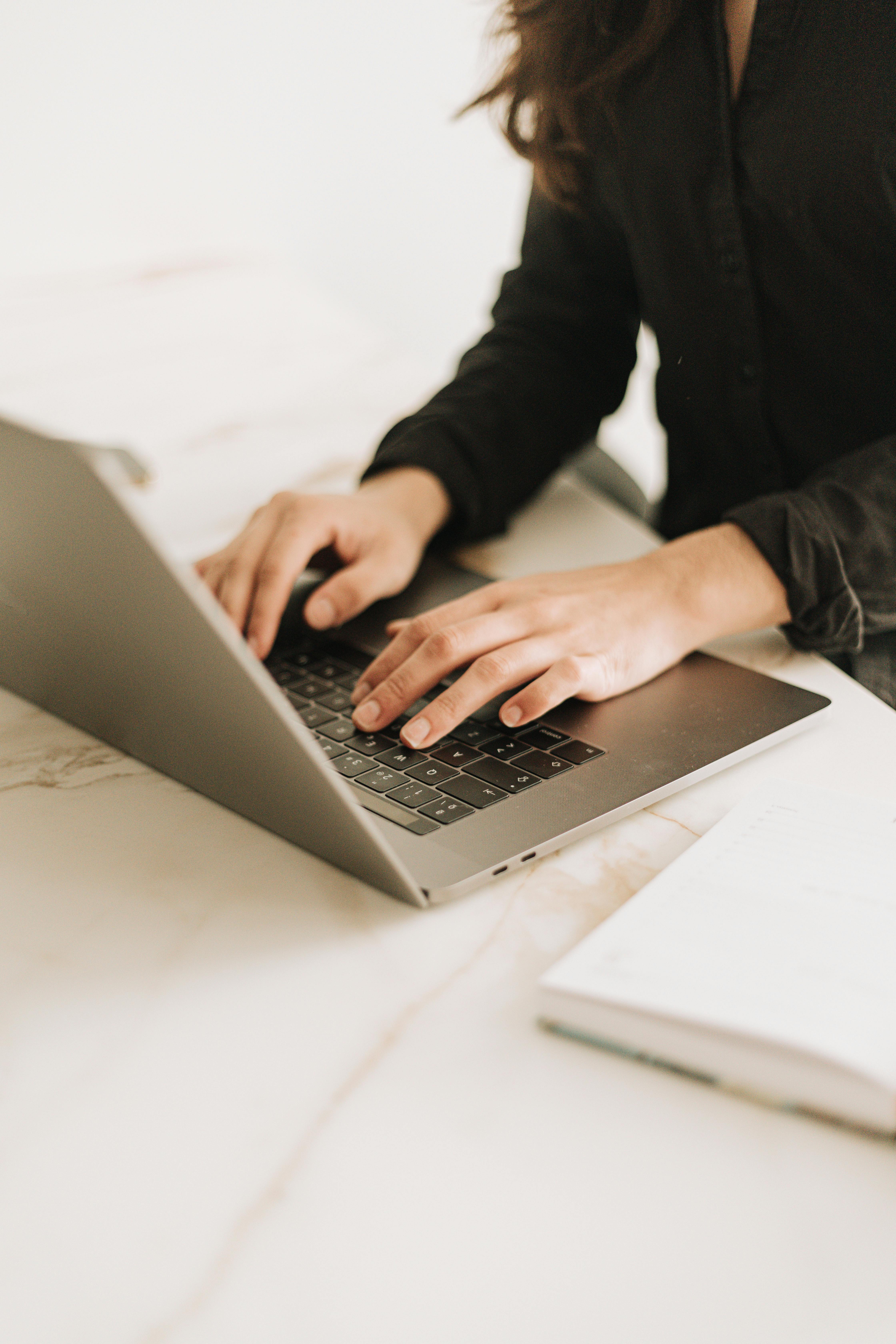 Established service provider working at a laptop representing sustained marketing effort without a defined quarterly direction.