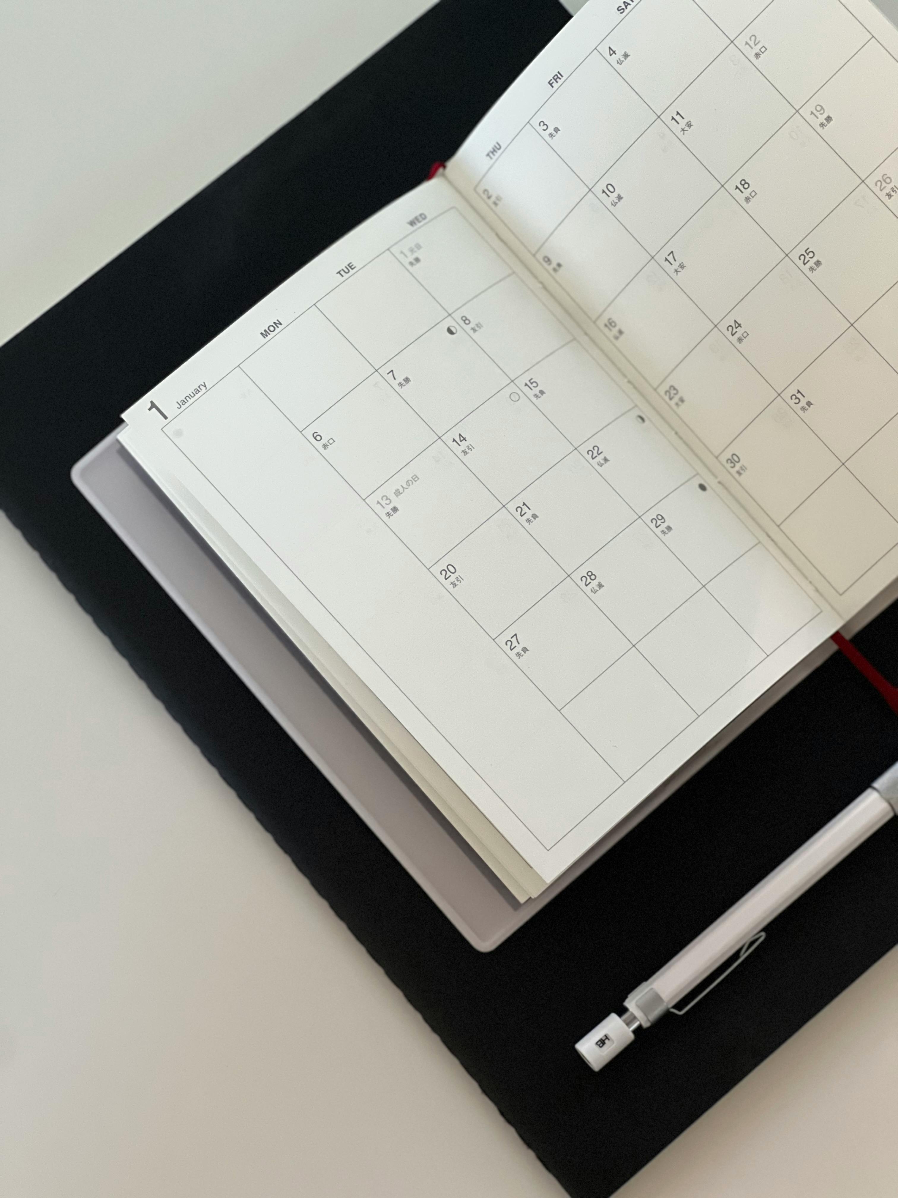 Open planner on a white desk representing the cost of another quarter without a defined strategic direction for an established service business.