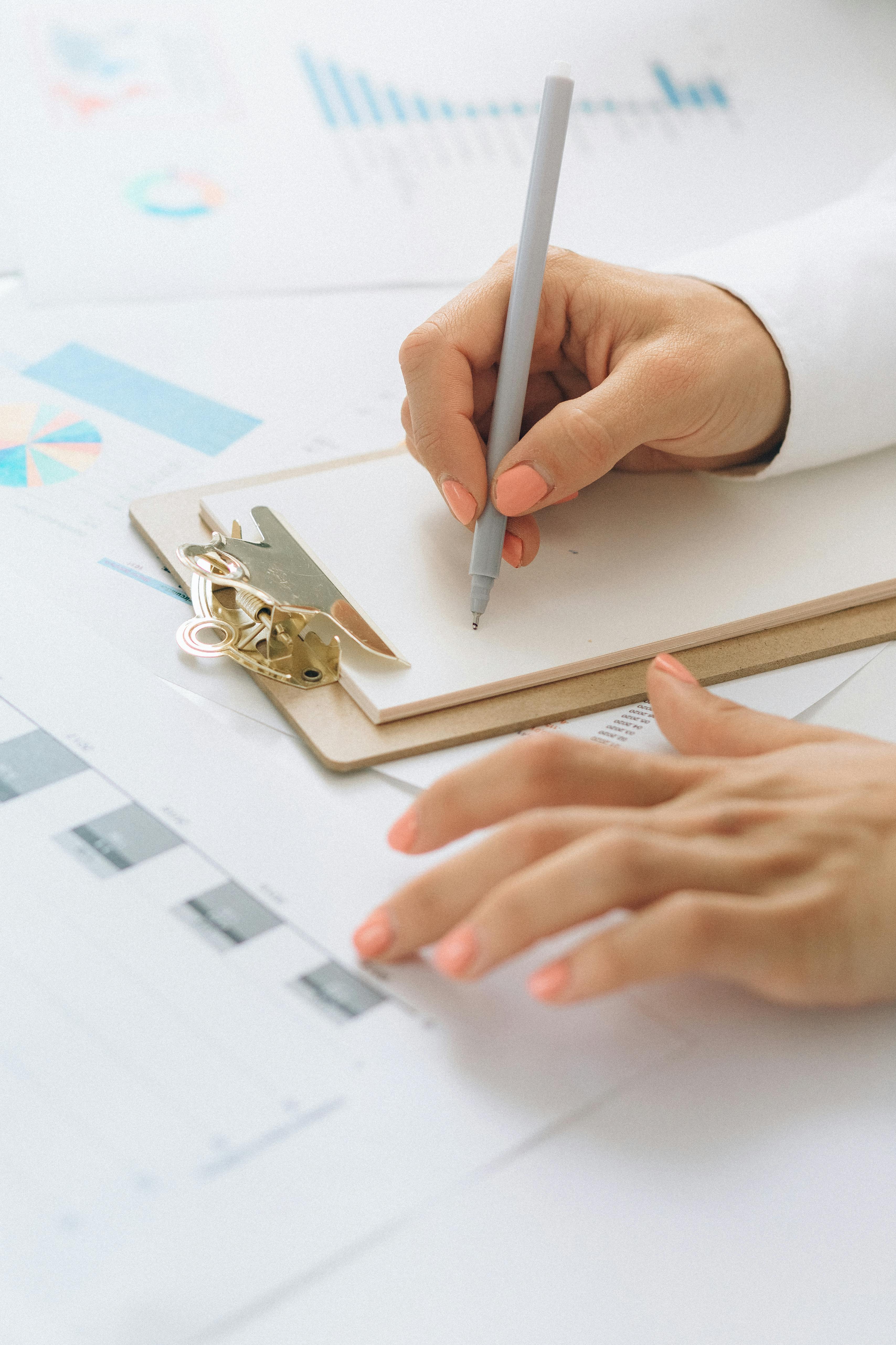 Hands reviewing data and notes Marketing funnel strategist investigating conversion data and identifying funnel leaks for a UK service business