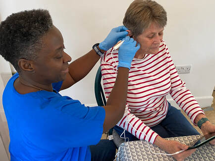 Safe ear inspection being performed during a home visit in Sussex