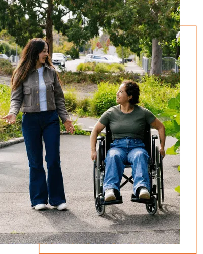 woman in wheelchair with support worker talking