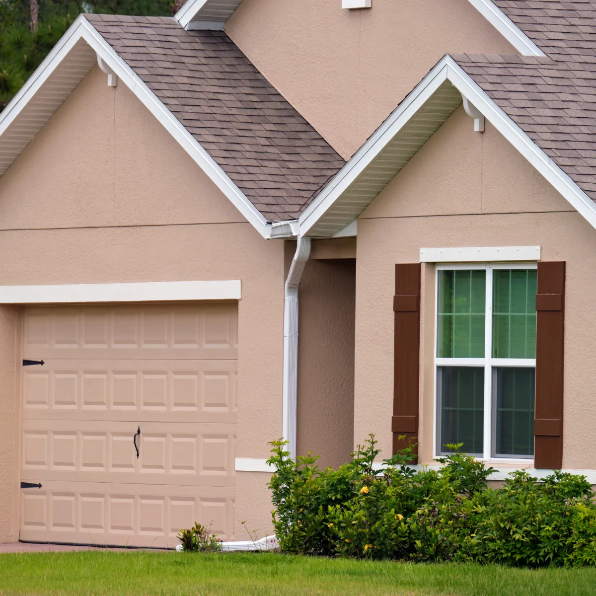 Exterior home with beige paint finish and detailed trim work completed by professional painters.
