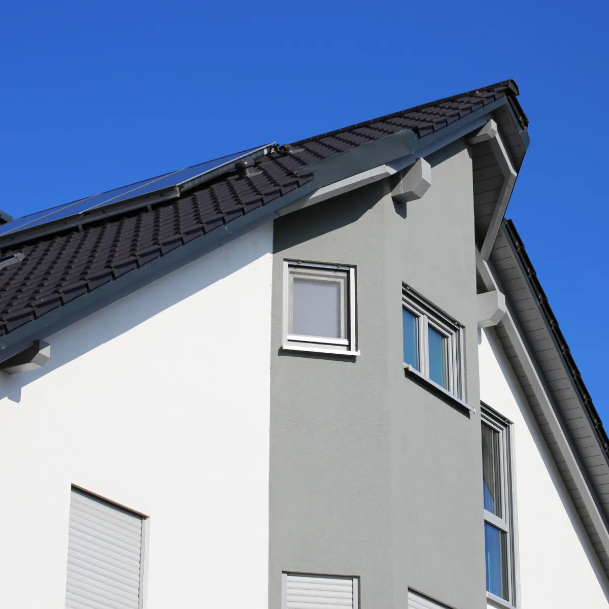 Modern exterior home painted in gray tones showing clean lines and smooth professional finish.