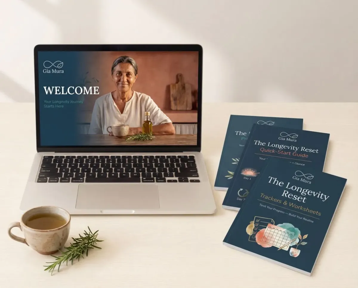The Longevity Reset 7-day video course displayed on a laptop with printable guides and a cup of herbal tea