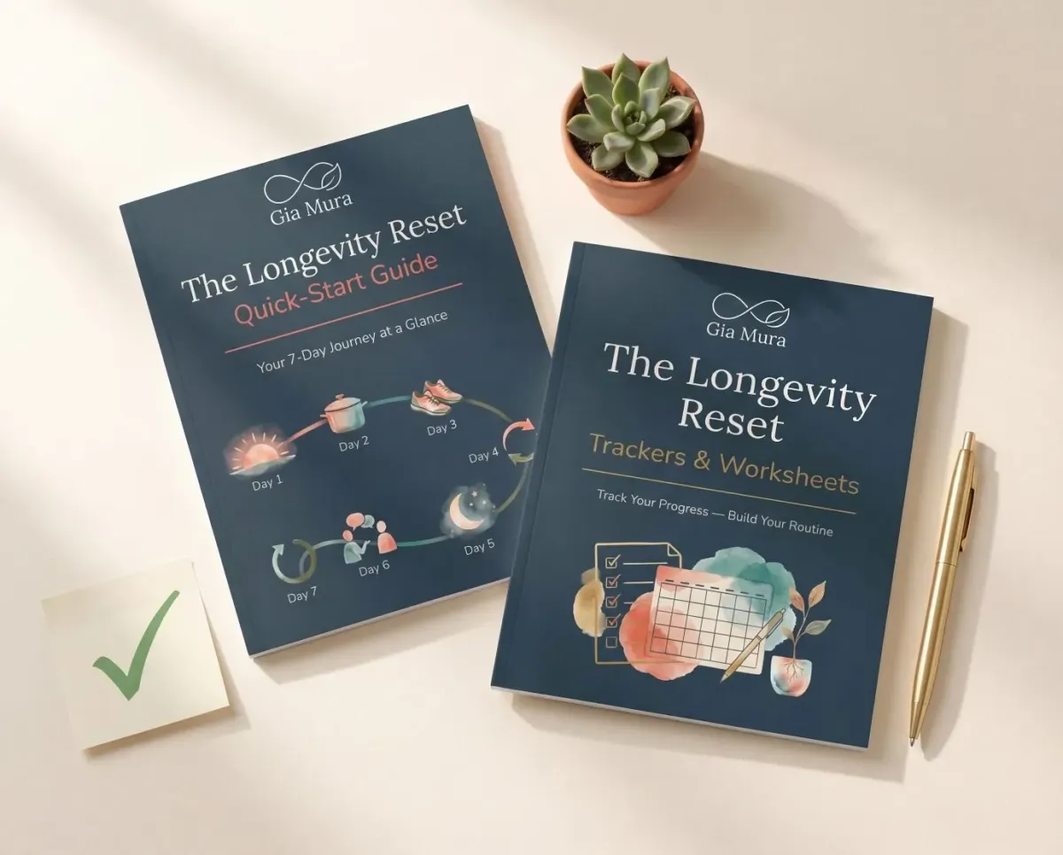 The Longevity Reset Quick Start Guide and Trackers and Worksheets booklets with a succulent plant and gold pen