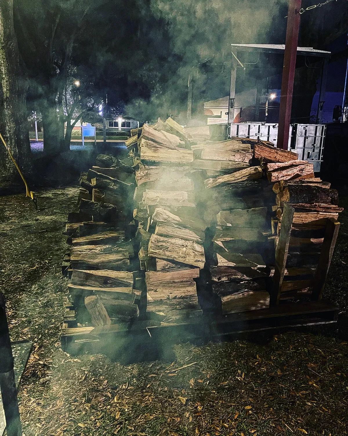 Smoke rising from the pit at night