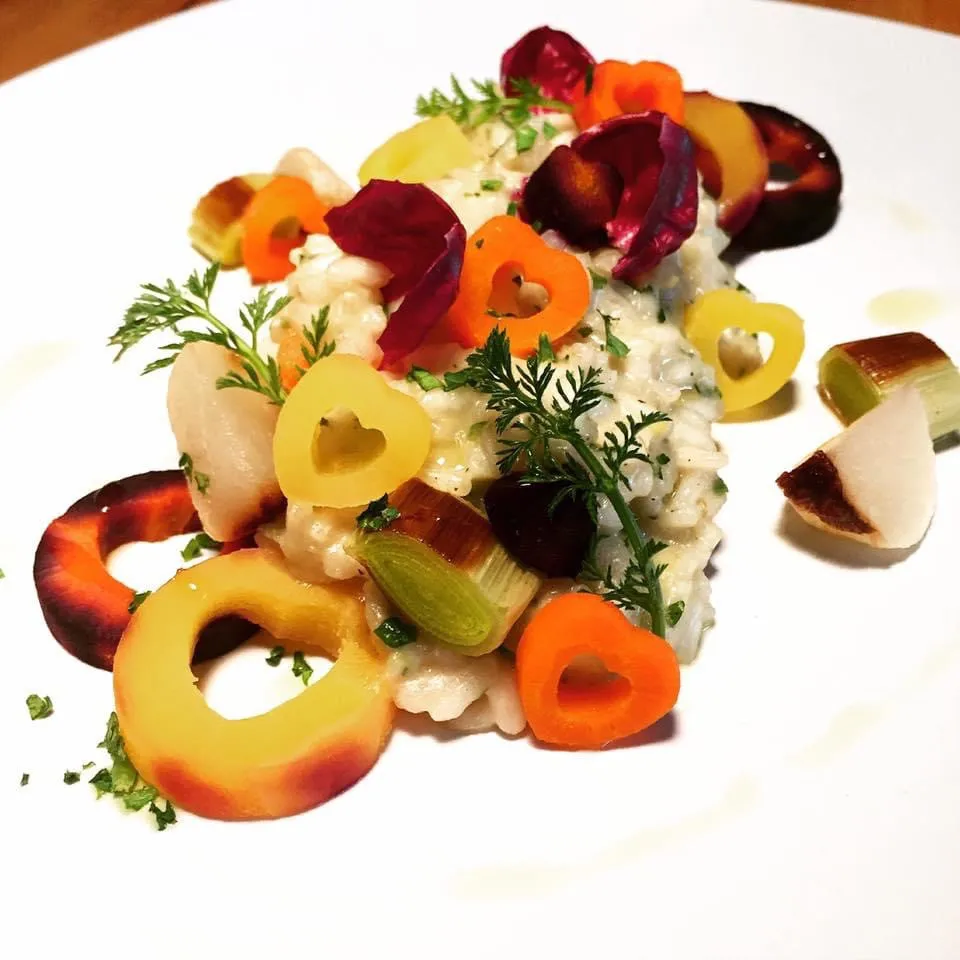 A plated course garnished with edible flowers