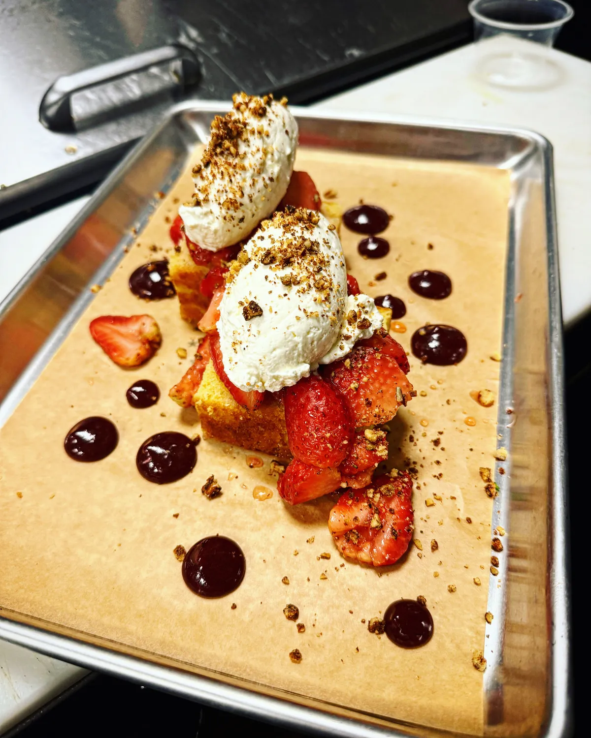 A plated dessert with berries and cream