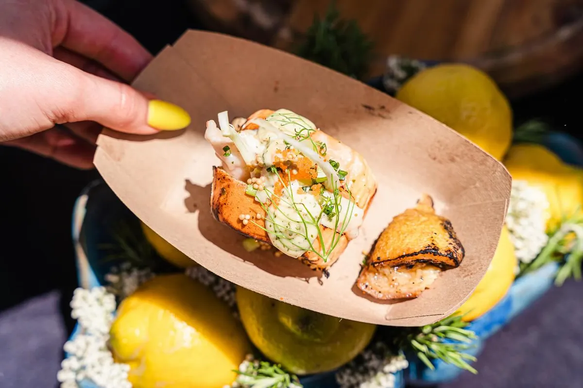 A boat of food held up at an event