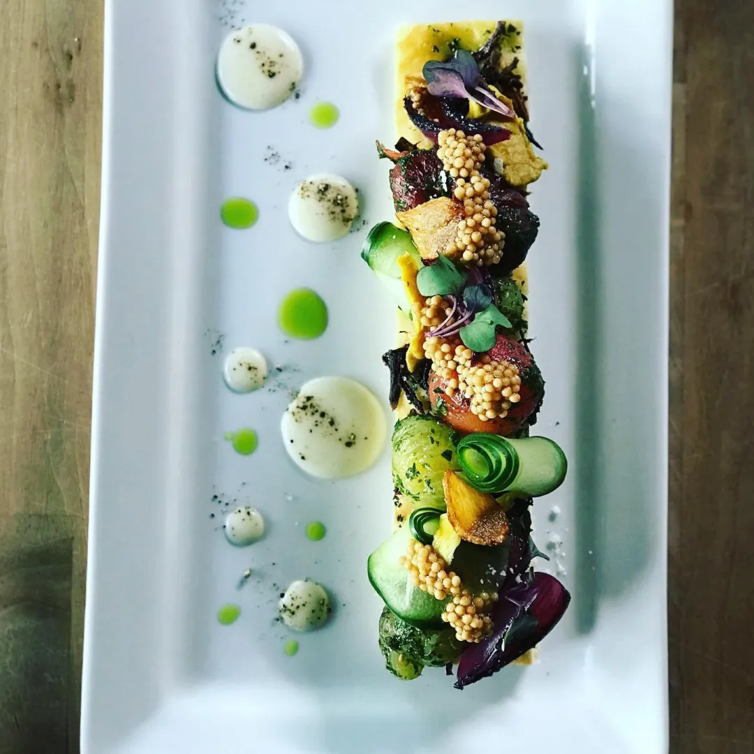 A row of canapés on a long white plate