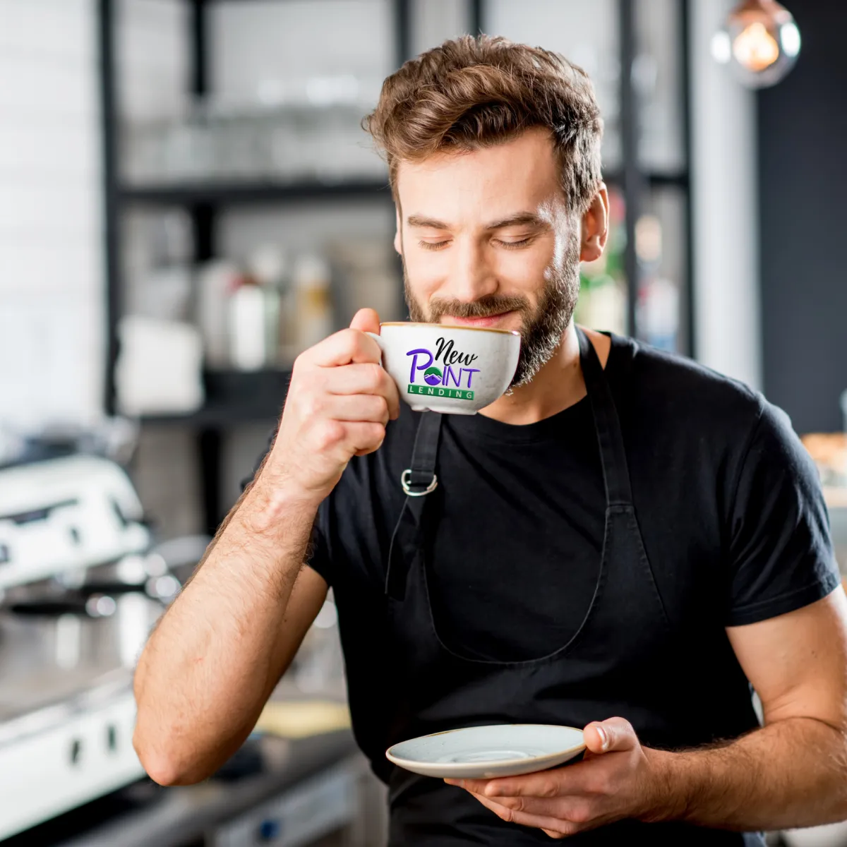 A young man sipping on a cup of coffee or tea.  Happy with his choice to submit his loan estimate for a compare and save review.