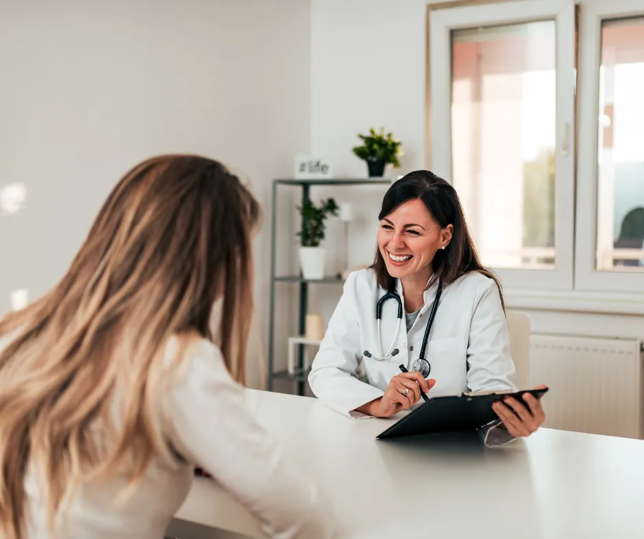 Doctor smiling while talking to patient.