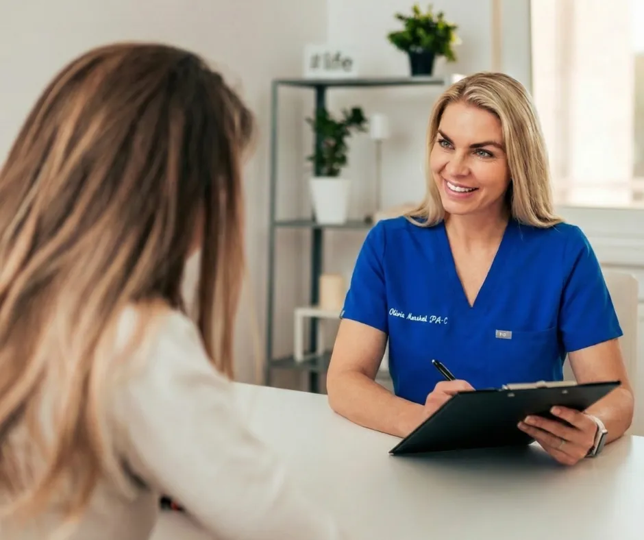 Doctor smiling while talking to patient.