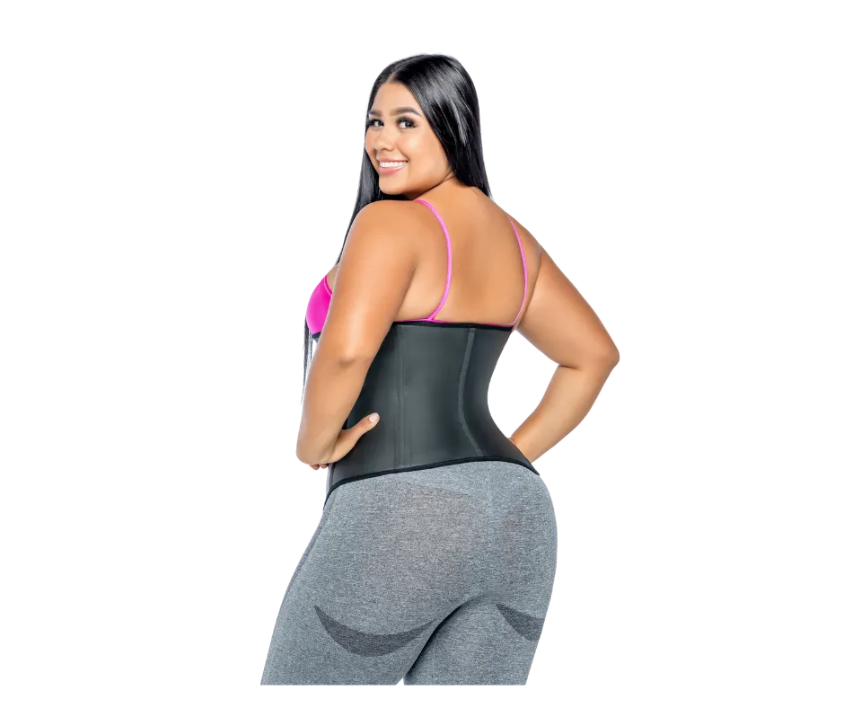 Confident woman in athletic wear holding a pink waist trainer, smiling brightly in a modern studio with soft lighting and a subtle pink gradient background. The image is vibrant, energetic, and aspirational, appealing to individuals interested in shapewear.