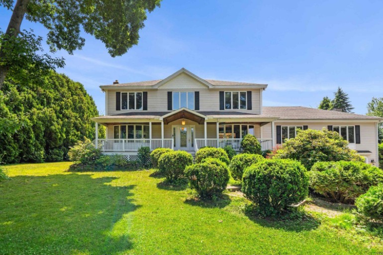A sprawling estate property in Southern New Hampshire with a large green lawn and historic home.