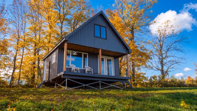 Custom cottage built on a sloped hillside using a Postech galvanized steel screw pile foundation.