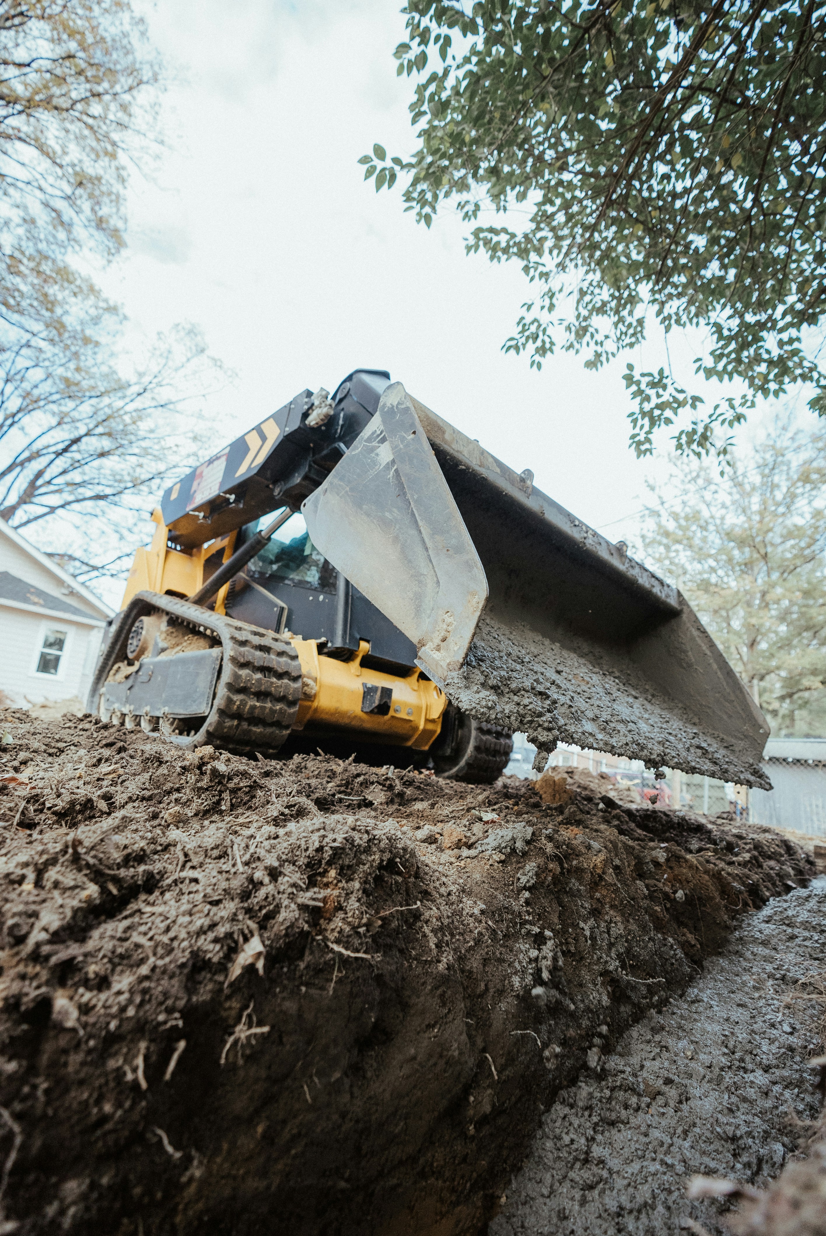Mini excavator digging a precise trench for site preparation and foundation work in Halton.