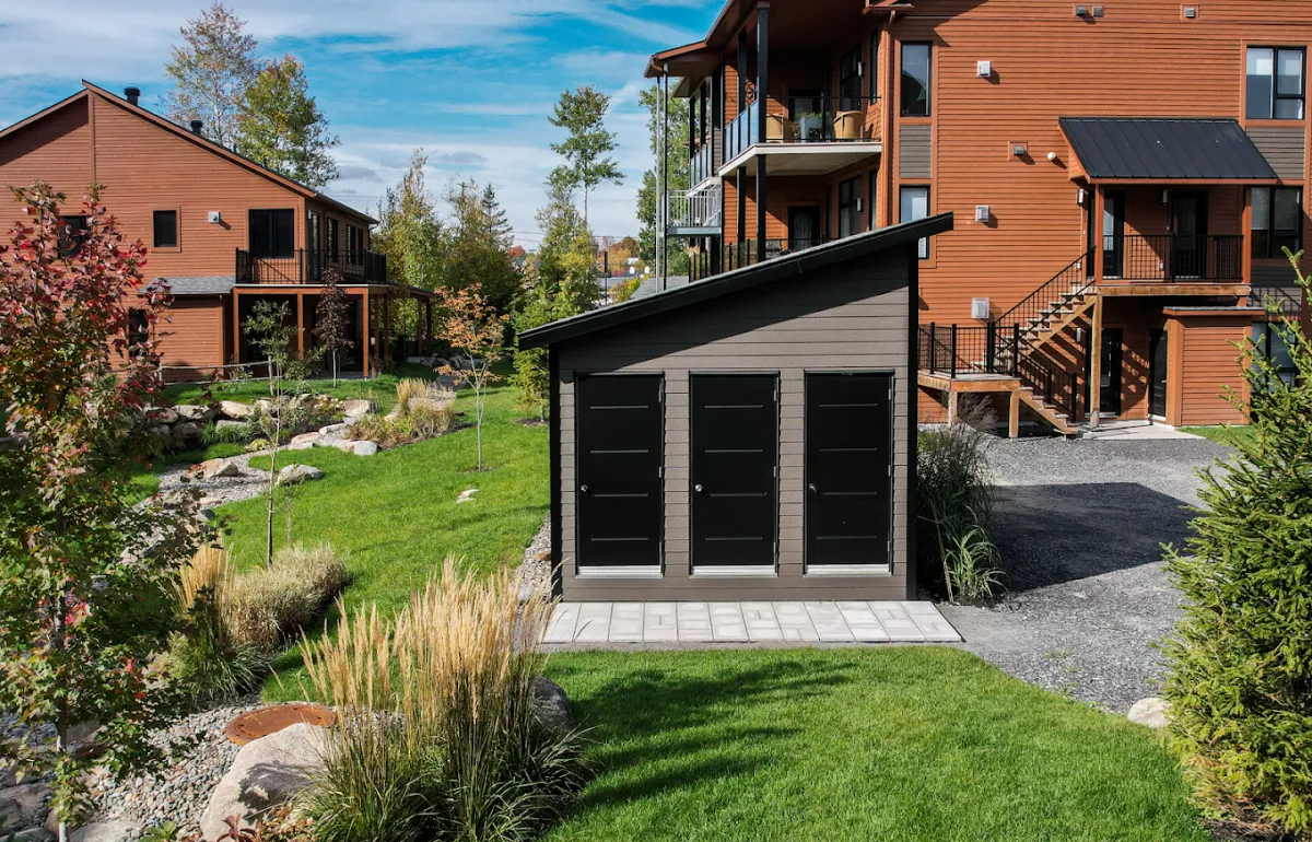 Modern outdoor storage shed built on a hidden foundation of Postech galvanized steel screw piles.