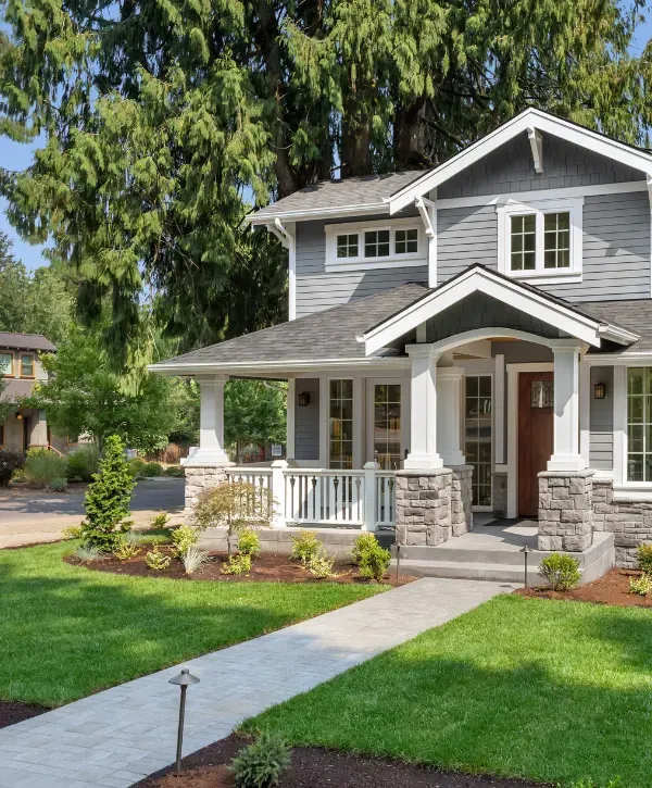 Clean residential front yard with pressure-washed sidewalk and vibrant landscaping