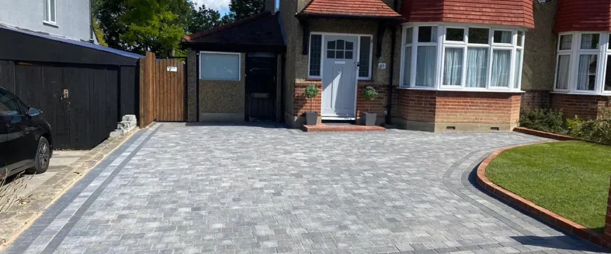Residential home with newly installed paver driveway and front yard