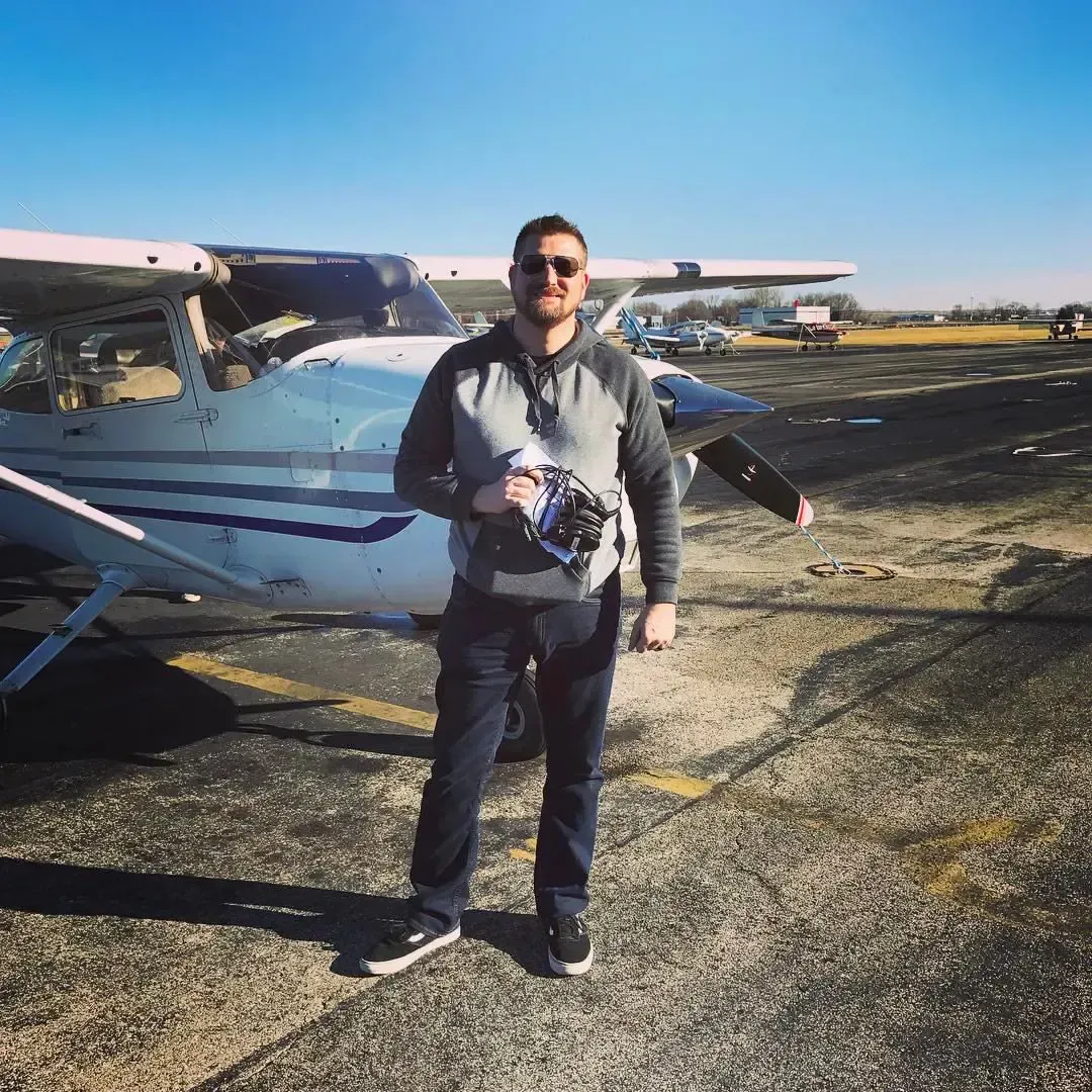 John Launius standing in front of an airplane