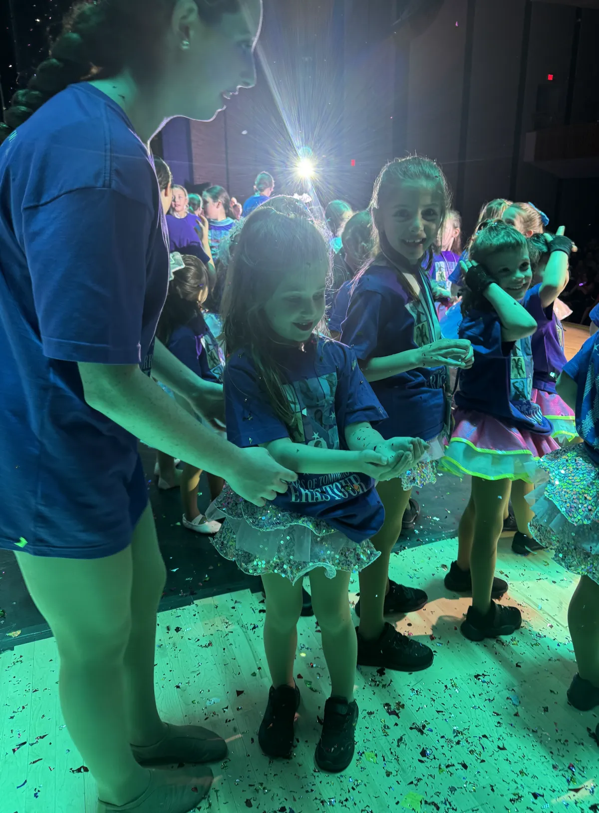 Young dancers lined up backstage waiting to perform