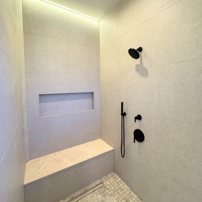 Austin shower remodel with custom tile surround and built in bench