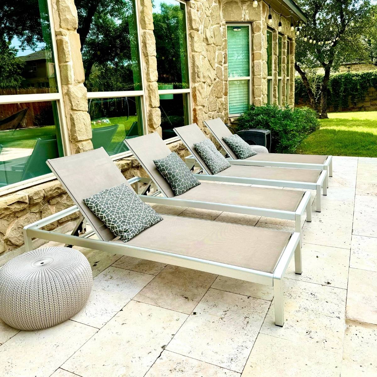 After: Austin backyard transformation featuring custom stone & tile lounging patio